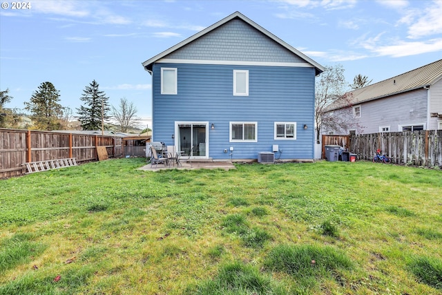 back of property with a yard and a patio