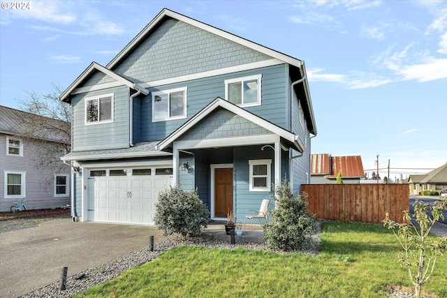 view of front of property with a front yard and a garage