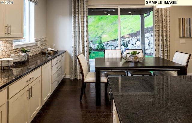 dining space featuring dark wood-type flooring and a healthy amount of sunlight