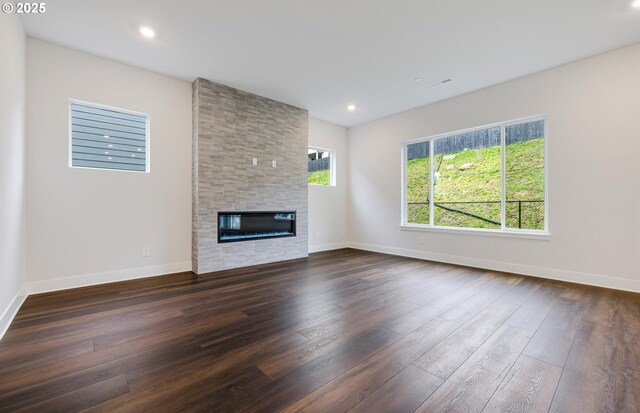 kitchen featuring high end refrigerator, plenty of natural light, white cabinets, and decorative light fixtures