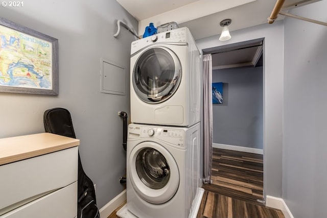 laundry room with stacked washer / dryer and dark hardwood / wood-style floors