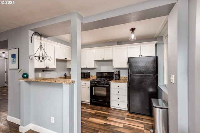 kitchen featuring light stone counters, black appliances, dark hardwood / wood-style floors, and white cabinets