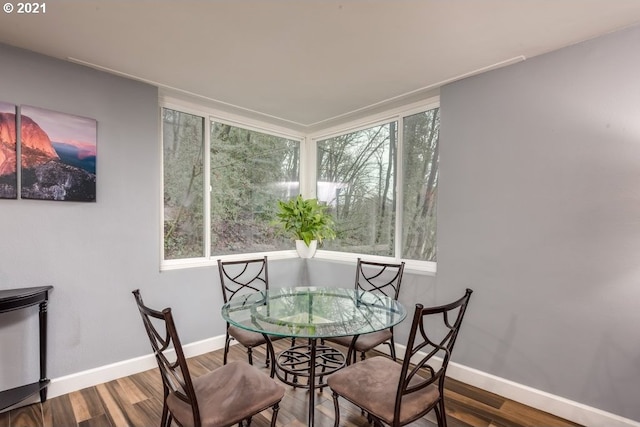 dining space with hardwood / wood-style flooring