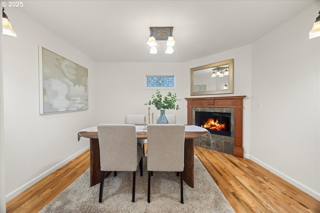 dining space featuring hardwood / wood-style floors and a fireplace