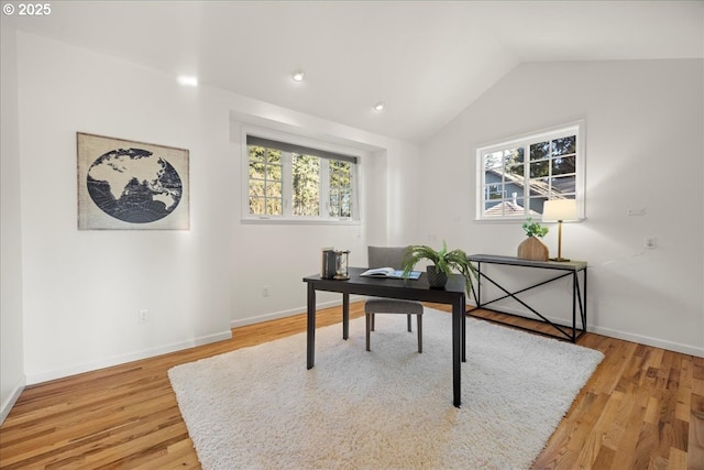 office area featuring vaulted ceiling and light hardwood / wood-style floors