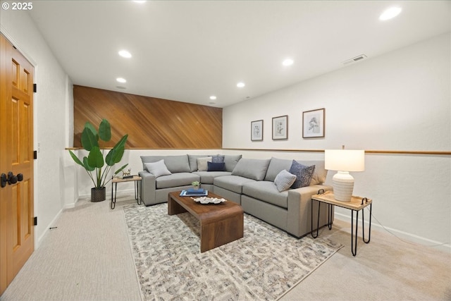 living room with light carpet and wood walls