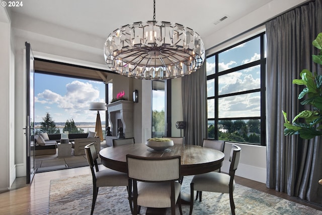 dining area featuring hardwood / wood-style floors and a notable chandelier