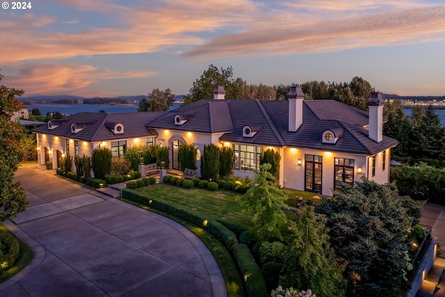 8001 SE Evergreen Hwy, Vancouver, WA 98660 - french country style house featuring french doors, a chimney, driveway, and a yard