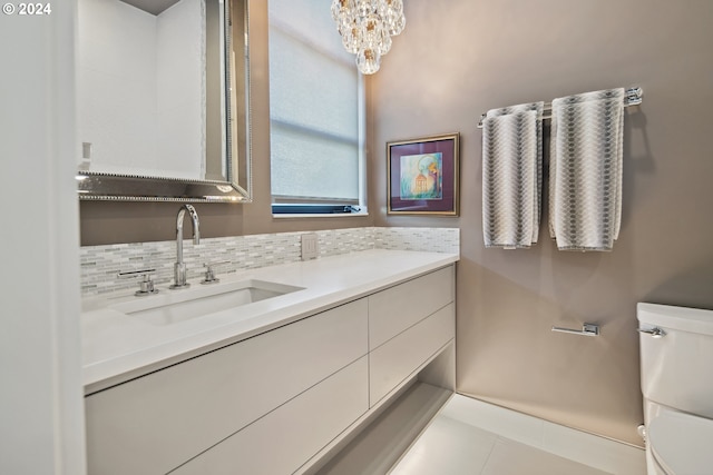 bathroom featuring decorative backsplash, vanity, toilet, and tile patterned floors