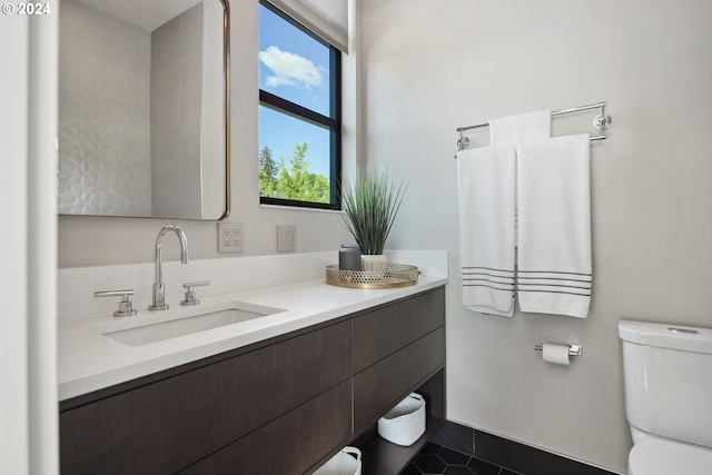 bathroom featuring vanity, toilet, and tile patterned floors