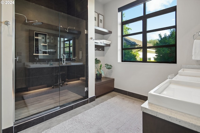 bathroom featuring an enclosed shower, vanity, and a wealth of natural light