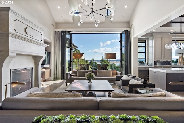 living room featuring high vaulted ceiling and an inviting chandelier