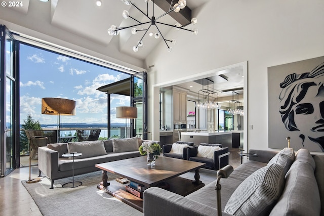 living room with high vaulted ceiling, wood-type flooring, and a water view