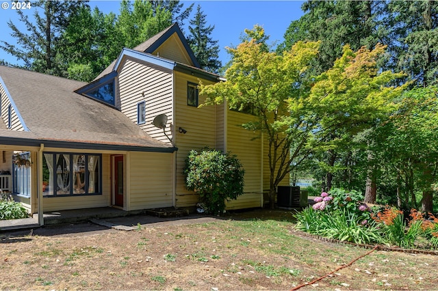 rear view of house featuring central AC unit