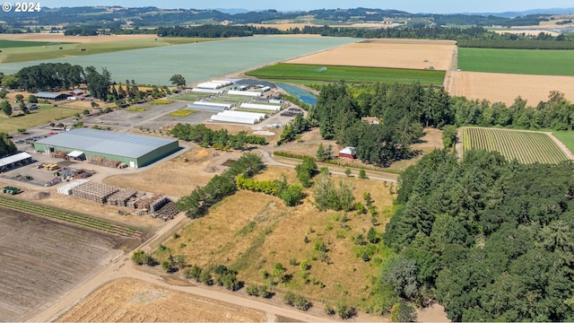 birds eye view of property with a water view and a rural view