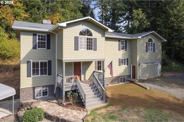 view of front of home with a porch and a garage