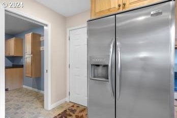 kitchen featuring stainless steel fridge and light brown cabinets