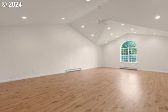 interior space featuring light hardwood / wood-style floors and lofted ceiling