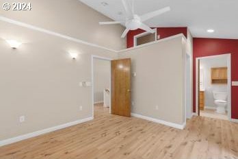 interior space featuring light hardwood / wood-style floors, lofted ceiling, and ceiling fan