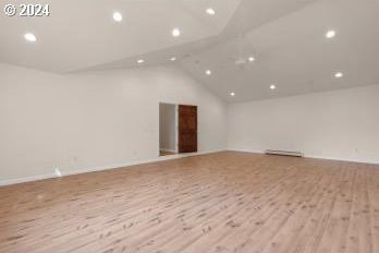 interior space with lofted ceiling and light wood-type flooring