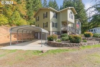 rear view of property featuring a carport