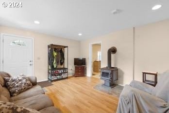 living room featuring a wood stove and hardwood / wood-style floors