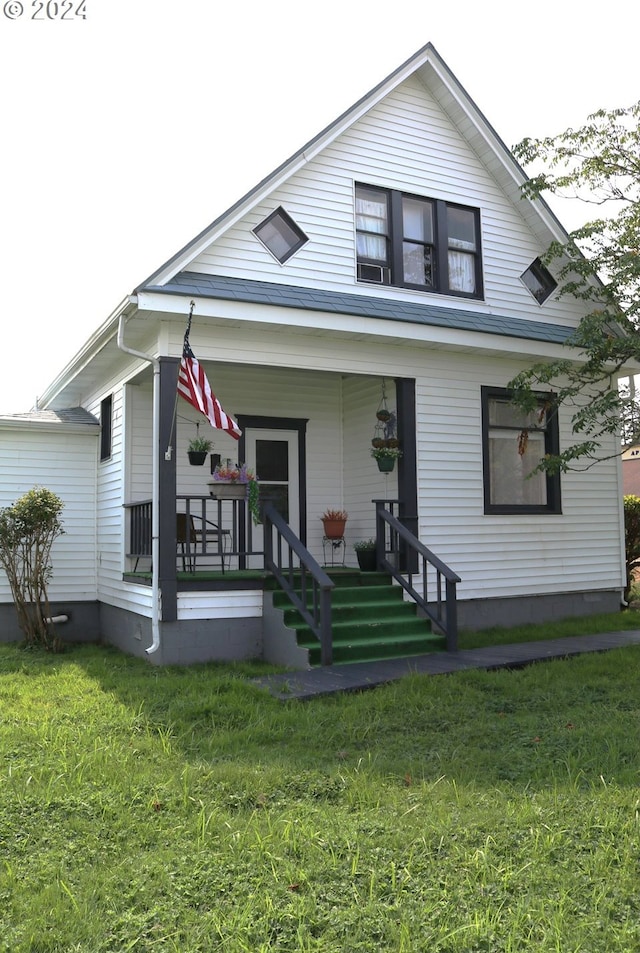 view of front of property with a porch and a front yard