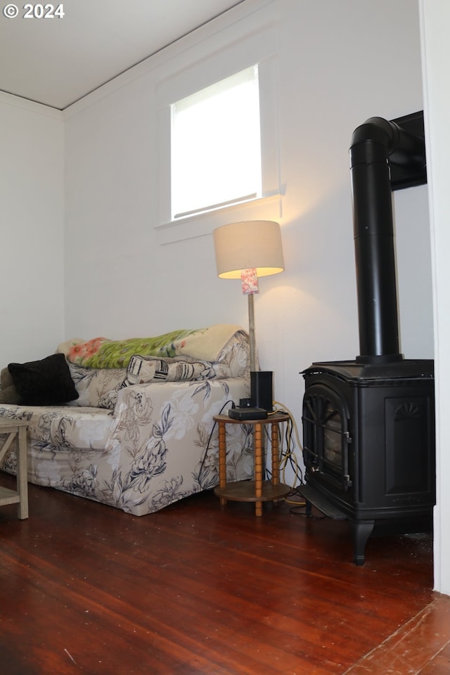 living room featuring wood-type flooring and crown molding