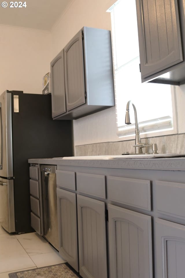 530 SE Marlin Ave, Warrenton, OR 97146 - kitchen featuring gray cabinets, light countertops, a sink, freestanding refrigerator, and ornamental molding