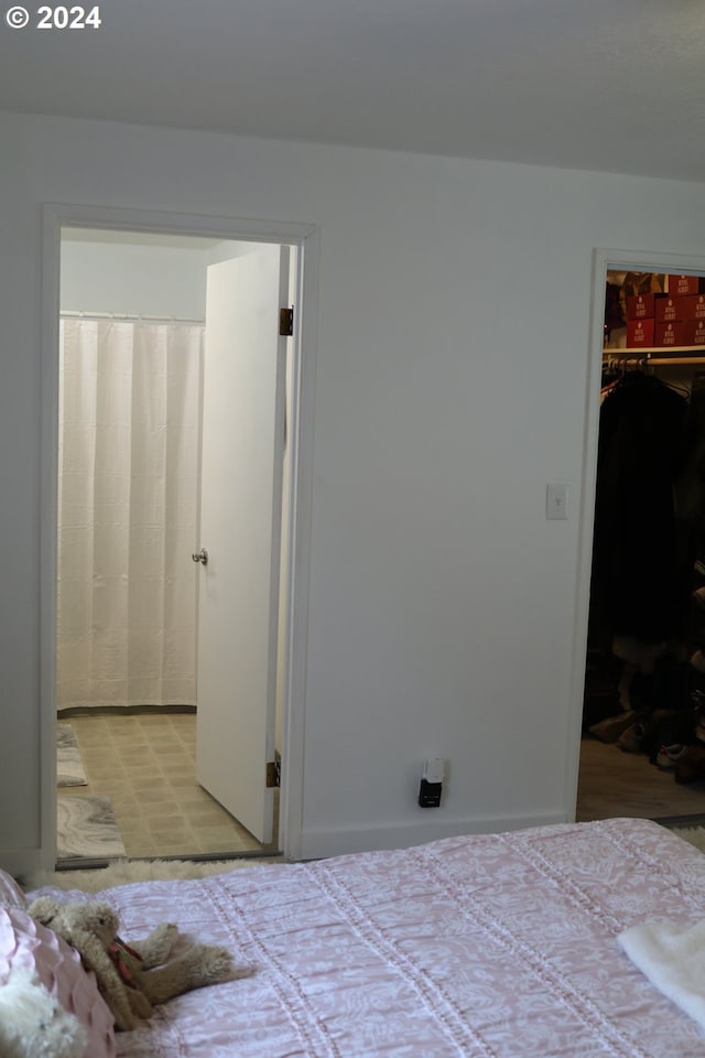 bedroom with a spacious closet and a closet