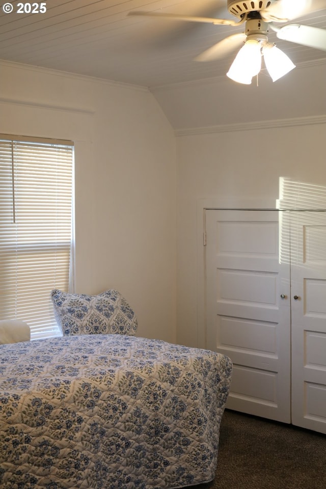 530 SE Marlin Ave, Warrenton, OR 97146 - bedroom with crown molding, dark colored carpet, vaulted ceiling, a ceiling fan, and a closet