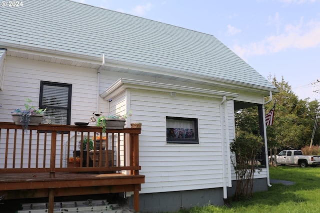 rear view of house featuring a wooden deck