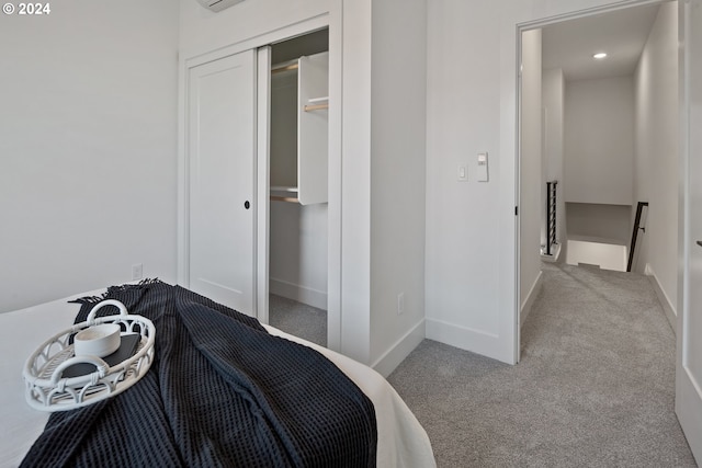 bedroom featuring light carpet and a closet