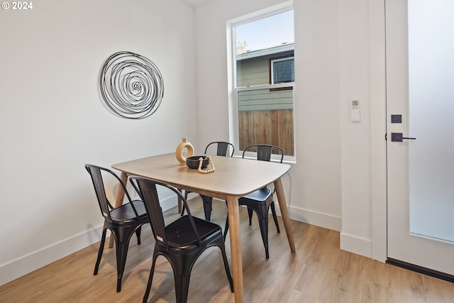 dining space featuring light wood-type flooring