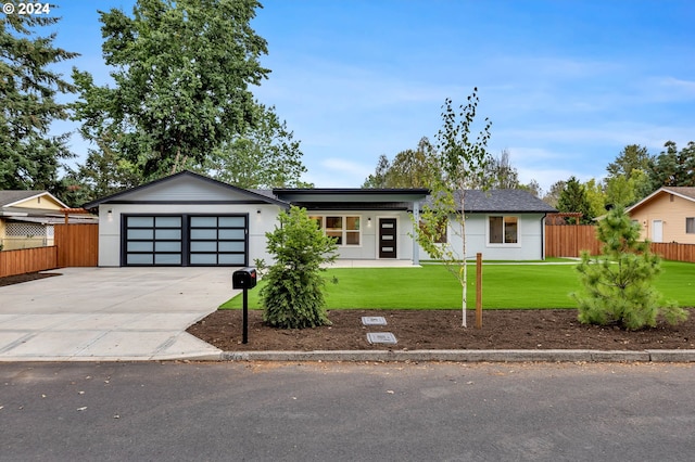 single story home featuring a front yard and a garage