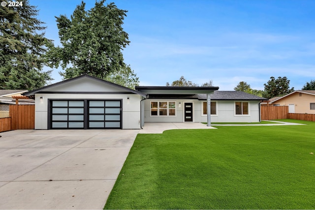 view of front of property with a garage and a front yard