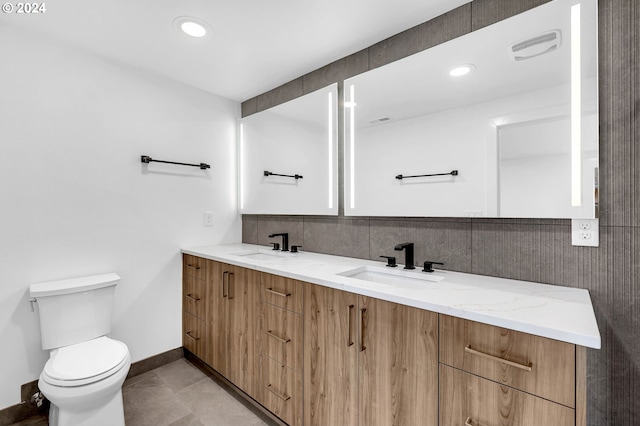 bathroom with vanity, toilet, and tile patterned floors