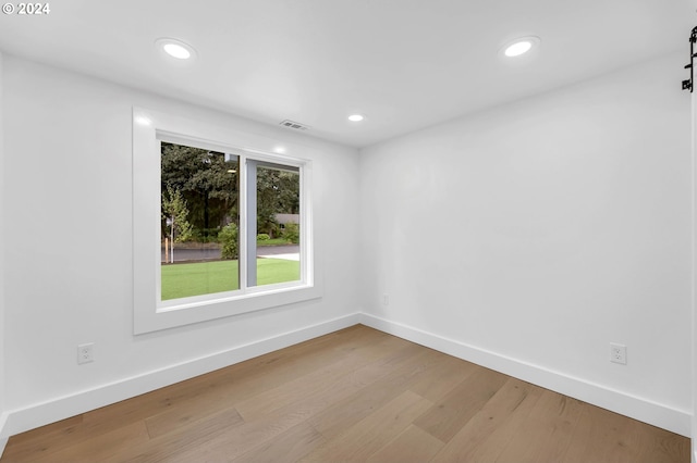 empty room with light hardwood / wood-style floors