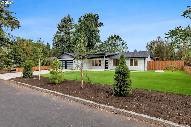 ranch-style home featuring a garage and a front lawn