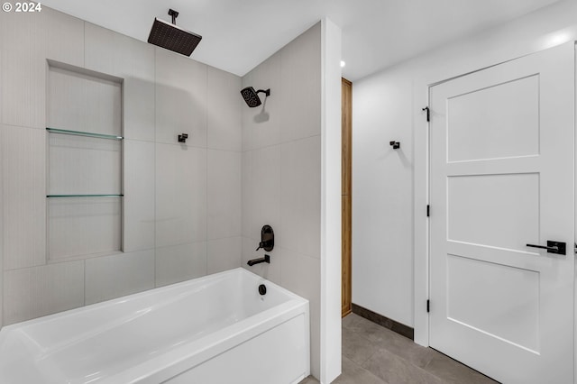 bathroom featuring tiled shower / bath combo and tile patterned flooring