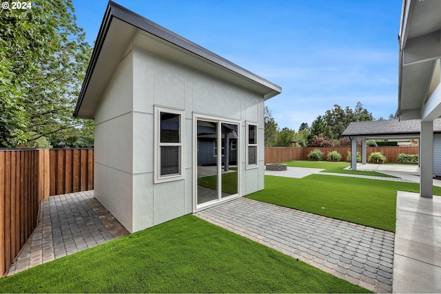 exterior space featuring a lawn and a patio area