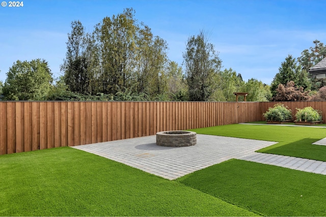 view of yard featuring a fire pit and a patio