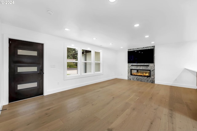 unfurnished living room featuring hardwood / wood-style flooring and a fireplace