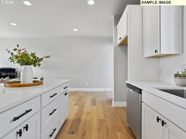 kitchen featuring light hardwood / wood-style flooring, white cabinetry, and stainless steel dishwasher