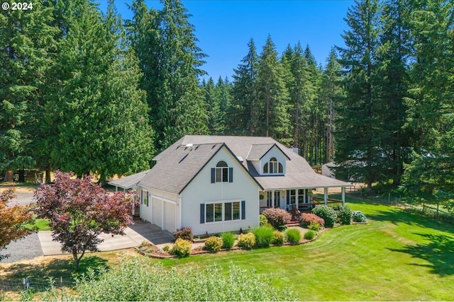 view of front of home featuring a front lawn, a porch, and a garage