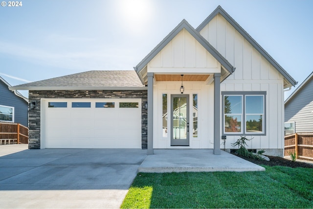 view of front of property featuring a garage and a front lawn