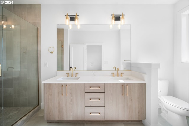 bathroom featuring vanity, toilet, and a shower with shower door