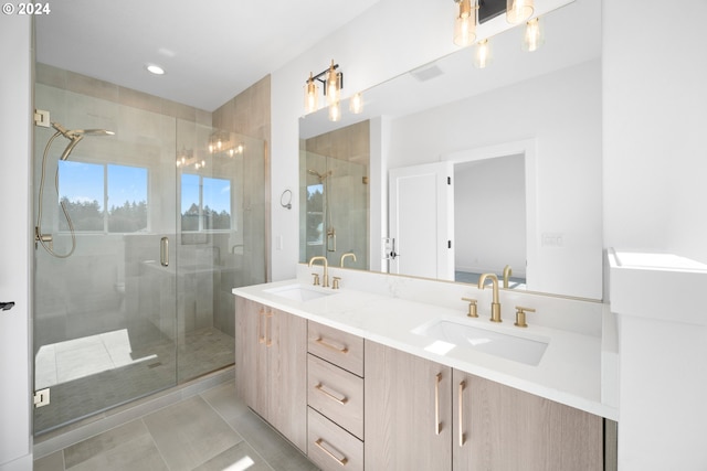 bathroom featuring a shower with door, vanity, and tile patterned flooring