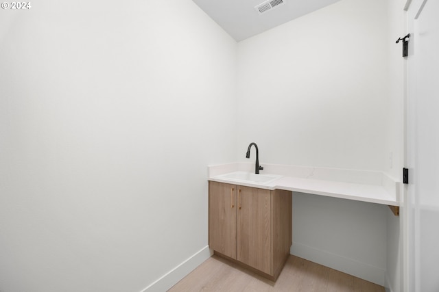 bathroom featuring hardwood / wood-style flooring and sink