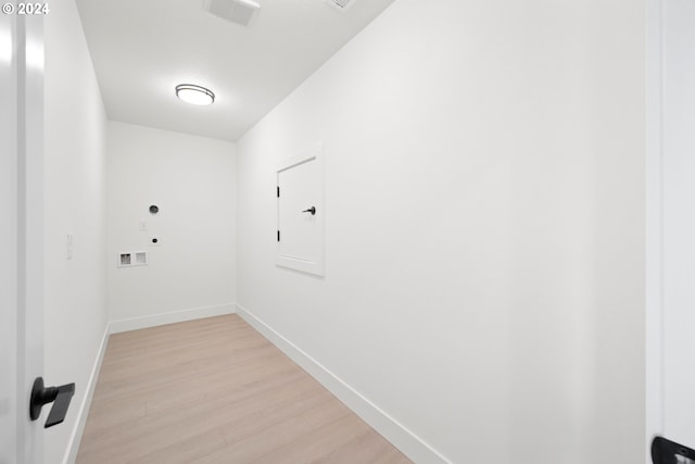 laundry area with washer hookup, electric dryer hookup, and light hardwood / wood-style floors